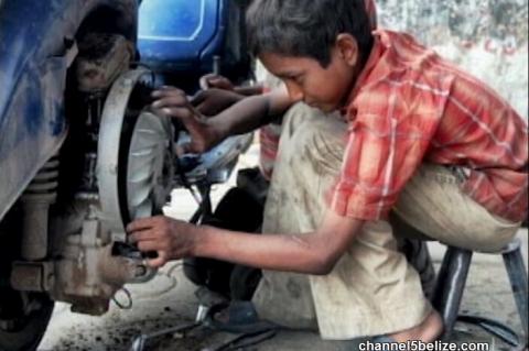 Young Boy working in a Mechanic Shop