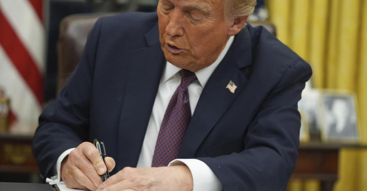 Incoming President Donal Trump Signing the first in a series of Executive Orders.