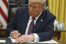 Incoming President Donal Trump Signing the first in a series of Executive Orders.